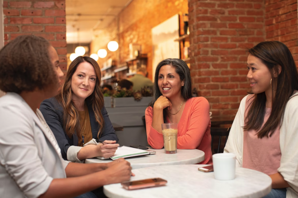 group of ladies sat around a table discussing